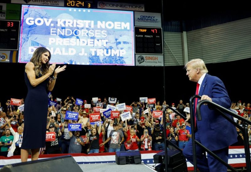 South Dakota Governor Kristi Noem welcomes former U.S. President and Republican presidential candidate Donald Trump before he speaks at a South Dakota Republican party rally in Rapid City, South Dakota, U.S. September 8, 2023. REUTERS/Jonathan Ernst