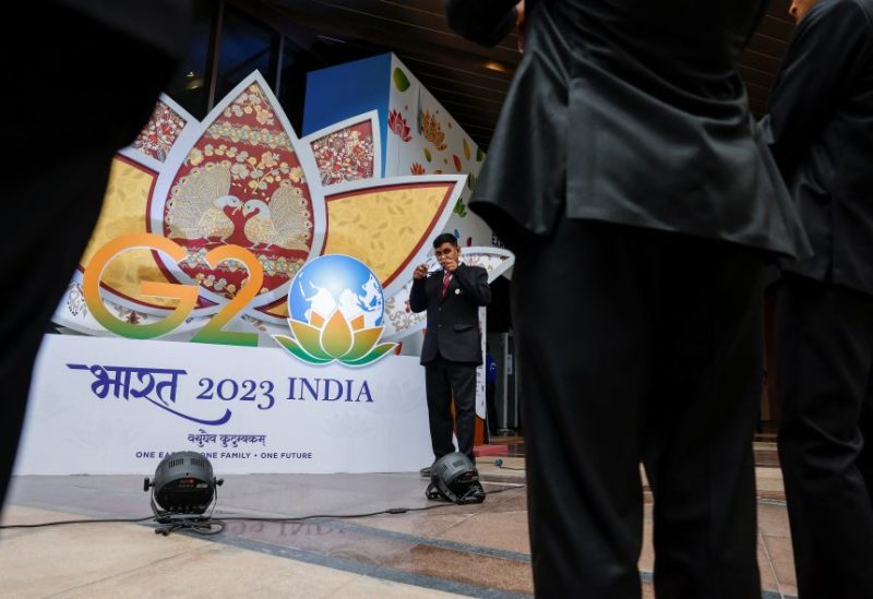 Indian security pose for selfies in front of a G20 sign outside the International Media Center during the G20 Summit in New Delhi, India, September 9, 2023. REUTERS/Evelyn Hockstein