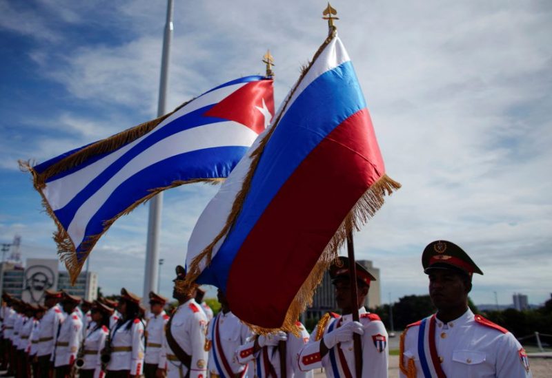 Honor guards hold a Russian and a Cuban flag during a wreath-laying ceremony with Russia's Prime Minister Dmitry Medvedev (not pictured) at the Jose Marti monument in Havana, Cuba, October 3, 2019. REUTERS/Alexandre Meneghini/File Photo