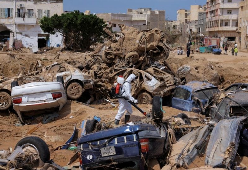 A sanitation worker disinfects rubble, amid rising concerns of spread of infectious diseases, as dead bodies started to decompose, following fatal floods in Derna, Libya, September 17, 2023. REUTERS/Amr Alfiky