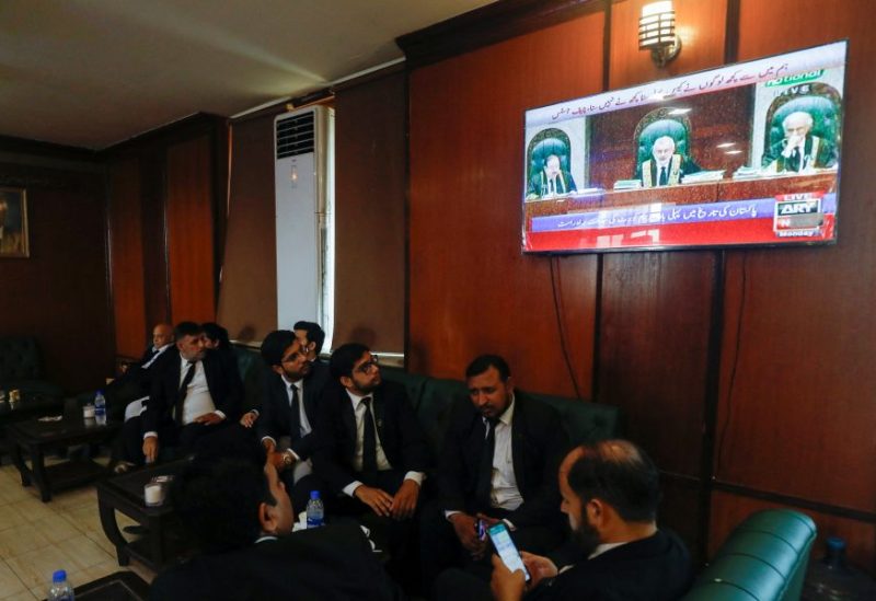 Lawyers, some of them look on television screen, dispaying the live broadcast of the proceeding from the Supreme Court of Pakistan, at the Sindh High Court Bar Association in Karachi, Pakistan September 18, 2023. REUTERS/Akhtar Soomro