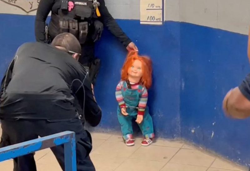 A police officer holds the handcuffed "demon doll" Chucky by its hair after arresting Carlos "N", a man who used the doll with a knife to rob people, according to local media, in Monclova, Mexico, September 11, 2023, in this screen grab obtained from a handout video. Noticias NRT Mexico/Handout via REUTERS