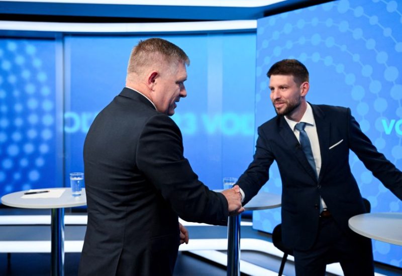 Robert Fico, leader of the SMER-SSD party, and Michal Simecka, leader of the Progressive Slovakia party, greet each other with a handshake before a televised debate at TV TA3, prior to the Slovak early parliamentary election, in Bratislava, Slovakia, September 26, 2023. REUTERS/Radovan Stoklasa