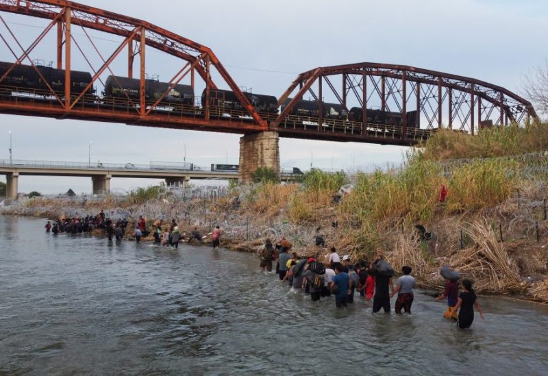 Asylum seekers cross the Rio Grande river to finish their journey through Mexico to Eagle Pass, Texas, U.S., as seen from Piedras Negras, Mexico September 26, 2023. REUTERS/Daniel Becerril