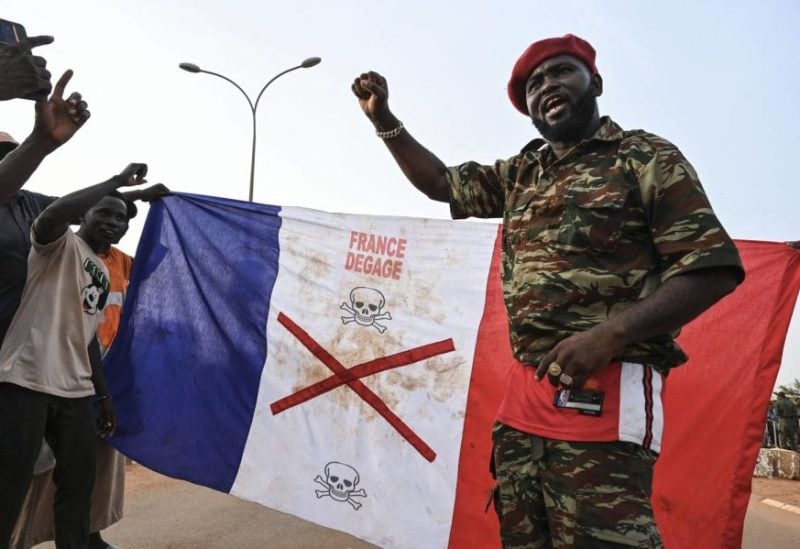 Supporters of Niger's National Council of Safeguard of the Homeland (CNSP) display a French national flag with a x-mark on during a protest outside Niger and French airbase in Niamey on September 1, 2023 to demand the departure of the French army from Niger. (Photo by AFP)