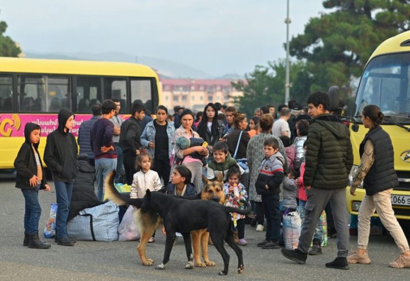 Residents gather next to buses in central Stepanakert before leaving Nagorno-Karabakh, a region inhabited by ethnic Armenians, September 25, 2023. REUTERS