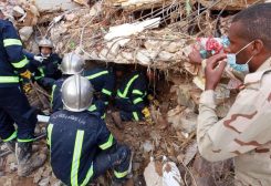 Fire and rescue teams search for survivors among the rubble of a collapsed building following floods that struck the city of Derna in eastern Libya, September 14, 2023 (AFP)