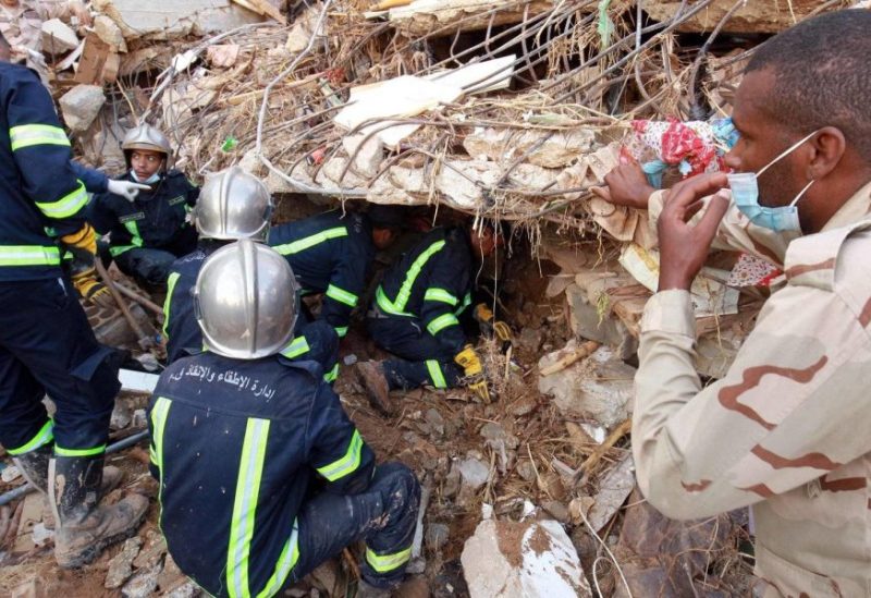 Fire and rescue teams search for survivors among the rubble of a collapsed building following floods that struck the city of Derna in eastern Libya, September 14, 2023 (AFP)