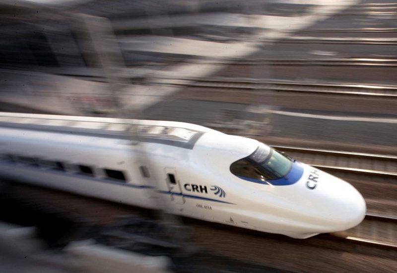 FILE PHOTO: FILE PHOTO: A bullet train speeds during its debut near a railway station in Shanghai January 28, 2007. REUTERS/Aly Song (CHINA)/File Photo