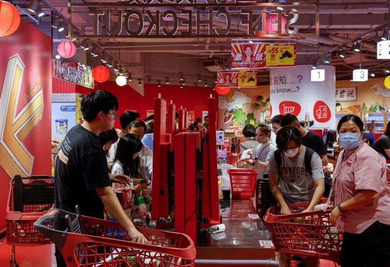 Customers queue at a supermarket to as super typhoon Saola approaches, in Hong Kong, China August 31, 2023. REUTERS/Tyrone Siu