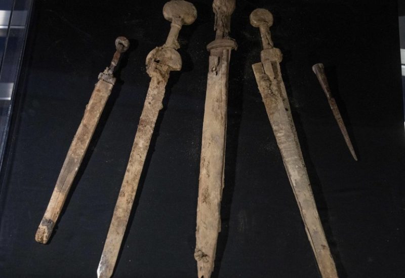 Israeli archaeologists show four Roman-era swords and a javelin head found during a recent excavation in a cave near the Dead Sea, in Jerusalem, Wednesday, Sep. 6, 2023. (AP Photo/Ohad Zwigenberg)