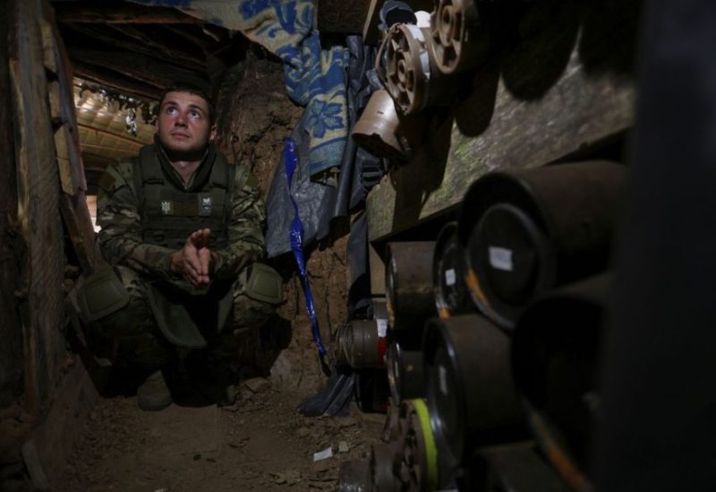 A Ukrainian serviceman sits next to mortar shells inside a dugout at a position near a frontline, amid Russia's attack on Ukraine, in Zaporizhzhia region, Ukraine September 4, 2023. REUTERS
