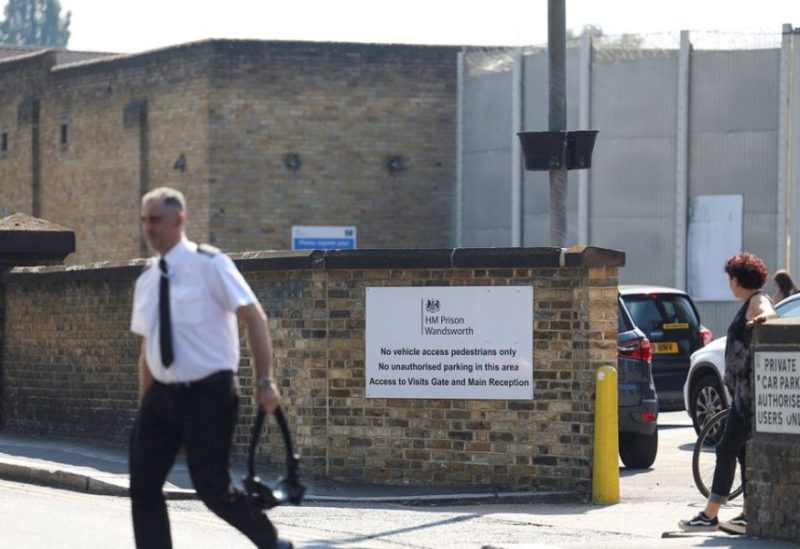 A man walks near a sign at Wandsworth prison where Daniel Abed Khalife, a former soldier who is suspected of terrorism offences, escaped, in London, Britain, September 7, 2023. REUTERS
