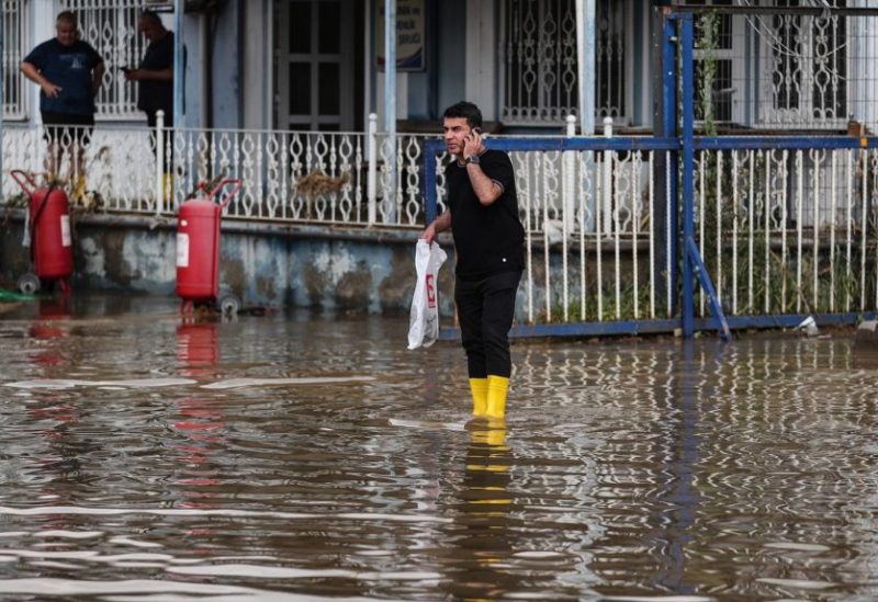 A man wades through floodwaters after floods hit the west districts of Istanbul, Türkiye, 06 September 2023. EPA/ERDEM SAHIN