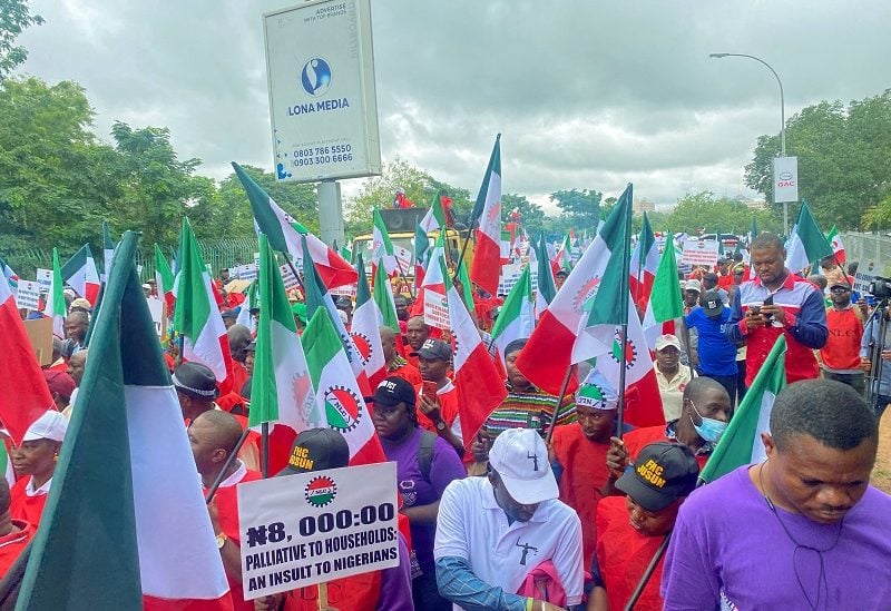 FILE PHOTO: Members of the Nigerian Labour Union, holding flags and placards, march during a protest against fuel price hikes and rising costs, in Abuja, Nigeria August 2, 2023. REUTERS/Abraham Achirga/File Photo