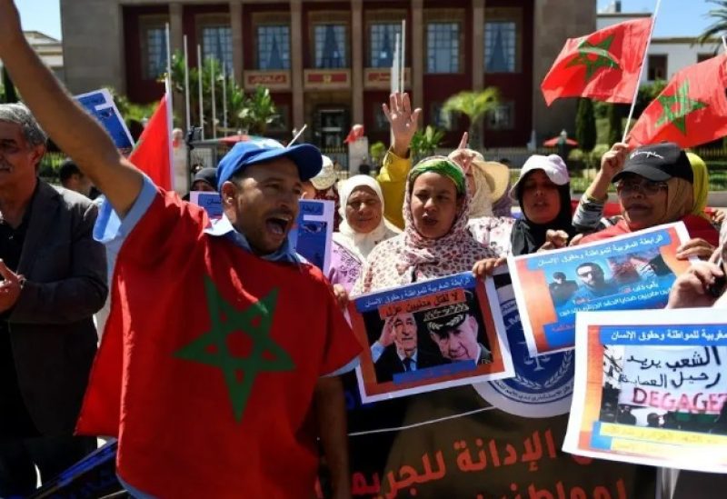 People hold banners and gather to stage a protest in Rabat, Morocco, Monday, Sept. 4, 2023, to condemn the killing of two men by Algerian forces after they strayed across Morocco's maritime border with Algeria on water scooters. (AP)