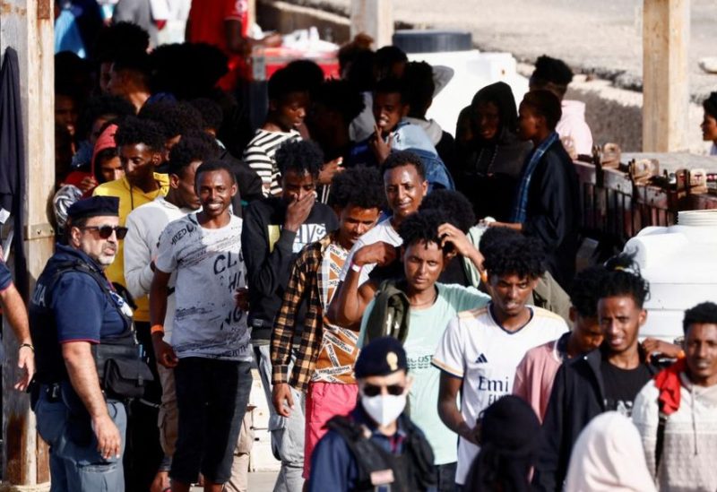 Migrants rescued at sea walk after disembarking from a vessel, on the Sicilian island of Lampedusa, Italy, September 18, 2023. REUTERS