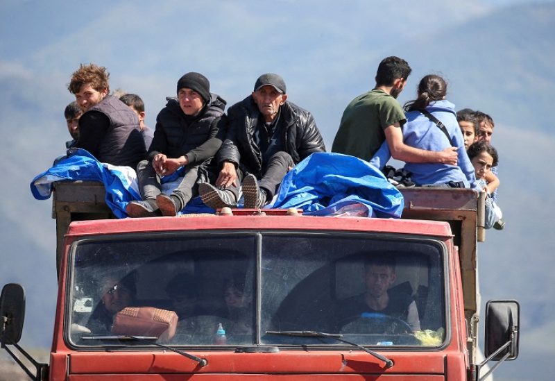 FILE PHOTO: Refugees from Nagorno-Karabakh region ride in a truck upon their arrival at the border village of Kornidzor, Armenia, September 27, 2023. REUTERS/Irakli Gedenidze TPX IMAGES OF THE DAY/File Photo