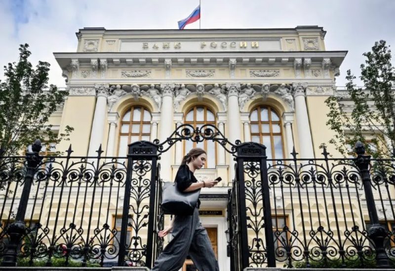 A woman walks past the Russian Central Bank headquarters in downtown Moscow on September 6, 2023. (AFP)
