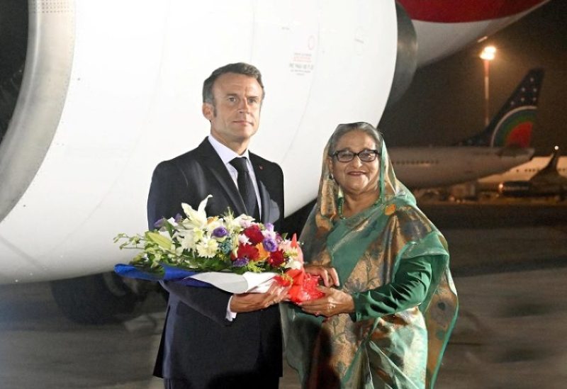 Sheikh Hasina, Prime Minister of Bangladesh welcomes French President Emmanuel Macron with flower bouquet at the Hazrat Shahjalal International Airport in Dhaka, Bangladesh, September 10, 2023. Prime Minister's Office of Bangladesh/Handout via REUTERS