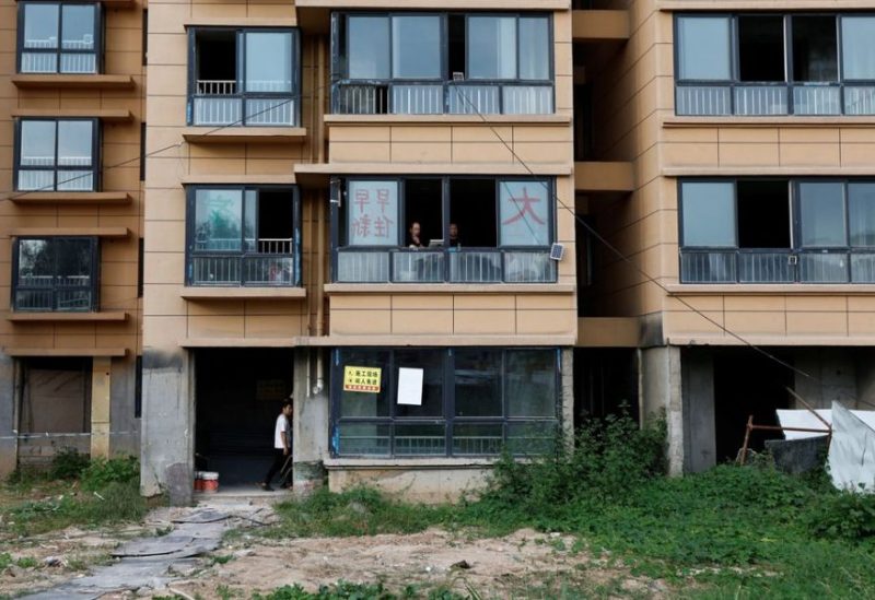 Home buyers stand inside an unfinished residential building of the Gaotie Wellness City complex in Tongchuan, Shaanxi province, China September 12, 2023. REUTERS