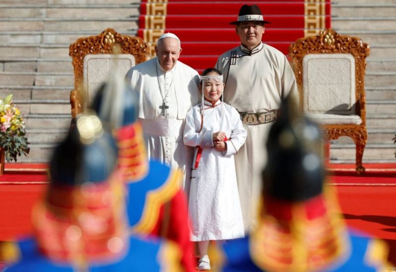 Pope Francis stands next to Mongolian President Ukhnaagiin Khurelsukh and Khulan Ganbat, 11, while attending a welcoming ceremony at Sukhbaatar Square, during his Apostolic Journey in Ulaanbaatar, Mongolia September 2, 2023. REUTERS