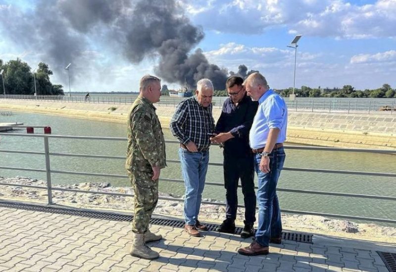 In this image released by the Romanian Defense Ministry, Defense Minister Angel Tilvar, second from left, visits areas in the Danube Delta close to the Ukrainian border, Wednesday, Sept. 6, 2023. (Romanian Defense Ministry via AP)