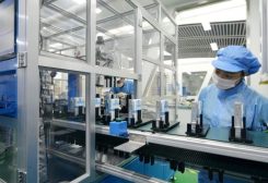 Workers are seen at the production line of lithium-ion batteries for electric vehicles (EV) at a factory in Huzhou, Zhejiang province, China August 28, 2018. REUTERS/Stringer