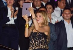 Gulnara Karimova (C), daughter of Uzbekistan's President Islam Karimov, takes a video with an Ipad as her father dances during an Independence Day celebration in Tashkent August 31, 2012. REUTERS/Shamil Zhumatov/File Photo