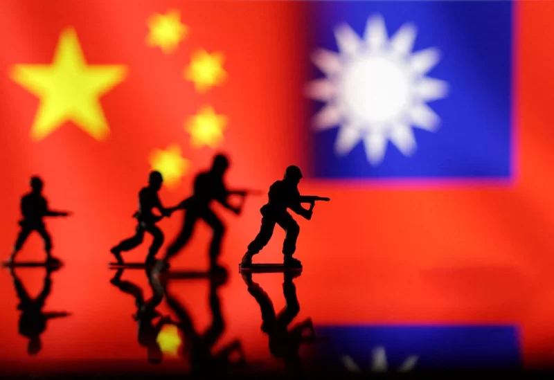 Solider miniatures are seen in front of displayed Chinese and Taiwanese flags in this illustration taken, April 11, 2023. REUTERS