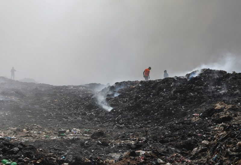 Palestinian firemen extinguish a fire at a landfill in Juhr al-Deek, southeast of Gaza City, September 3, 2023. REUTERS/Arafat Barbakh