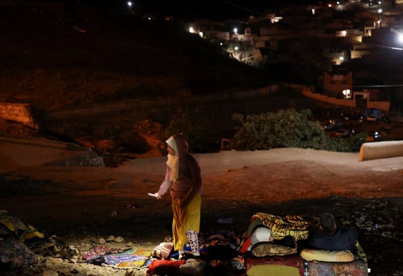 Residents rest on the street in Moulay Brahim village, in the province of Al Haouz, following a powerful earthquake in Morocco, September 9, 2023. REUTERS/Nacho Doce
