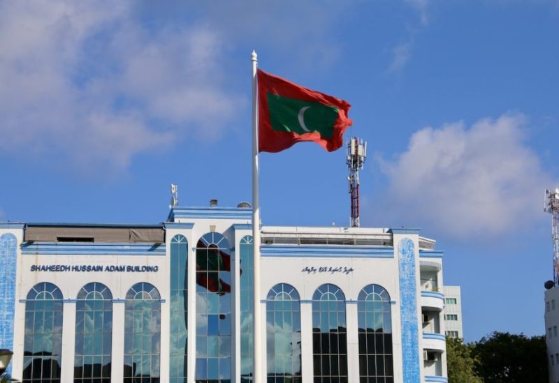A Maldives national flag flying on top of the Shaheed Hussain Adam building in Malé, North Malé Atoll, The Maldives