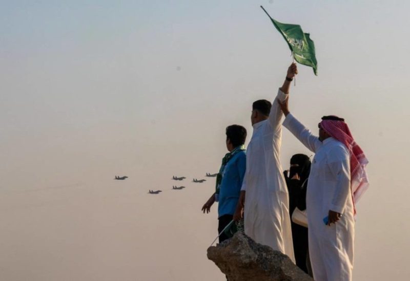 22 September 2023, Saudi Arabia, Riyadh: Saudis wave flags as aircraft perform to celebrate Saudi Arabia's National Day in Riyadh. (SPA)