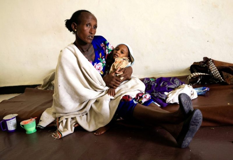 Maeru Adugna, 45 carries her son, Kibrom Woldesillasie, 2, severely malnourished due to the food aid suspension from the United Nations World Food Program (WFP) and the U.S. Agency for International Development (USAID) at the Samre Hospital in Samre, Tigray Region, Ethiopia, June 23, 2023. REUTERS/Tiksa Negeri/File Photo