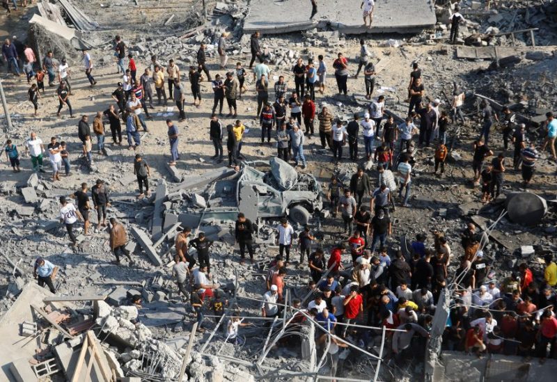 Palestinians search for casualties under the rubble in the aftermath of Israeli strikes, in Khan Younis in the southern Gaza Strip, October 14, 2023. REUTERS/Ibraheem Abu Mustafa