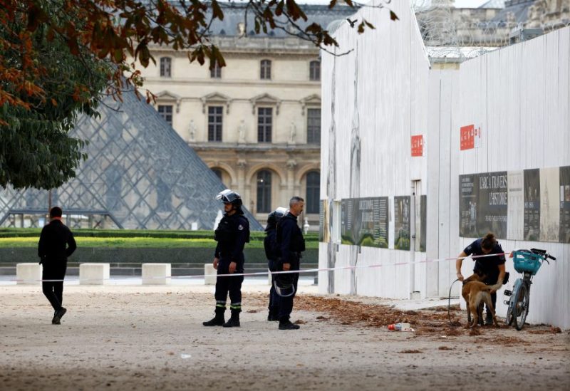French police officers keep watch in front of the Louvre museum, closed for security reasons, in Paris, as French government puts the nation on its highest state of alert after a deadly knife attack in northern France, October 14, 2023. REUTERS/Sarah Meyssonnier