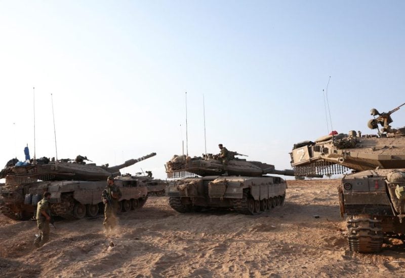 Israeli tanks are seen in the aftermath of a mass infiltration by Hamas gunmen from the Gaza Strip, in Kibbutz Beeri in southern Israel, October 14, 2023. REUTERS/Violeta Santos Moura