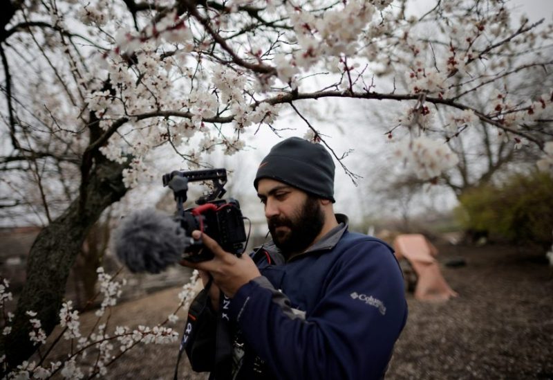 Reuters' journalist Issam Abdallah films Ukrainian woman Zhanna Lishchynska (not pictured) during an interview with Reuters, amid Russia's attack on Ukraine, in Zaporizhzhya, Ukraine April 17, 2022. REUTERS/Ueslei Marcelino/File Photo