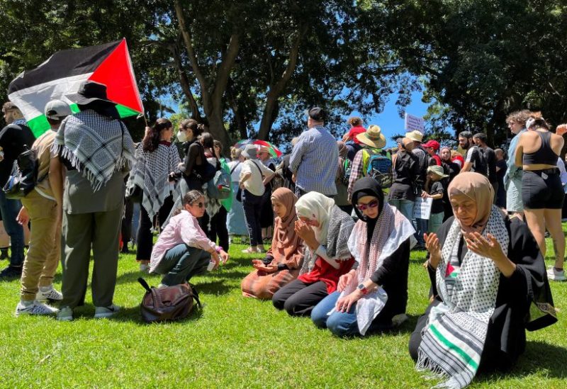 Women pray before a pro-Palestinian rally in Hyde Park, Sydney, Australia October 15, 2023. REUTERS/Lewis Jackson