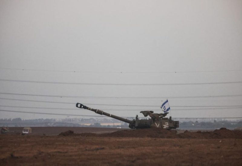 An Israeli flag flutters from a self-propelled howitzer near Israel's border with the Gaza Strip, in southern Israel, October 22, 2023. REUTERS/Violeta Santos Moura
