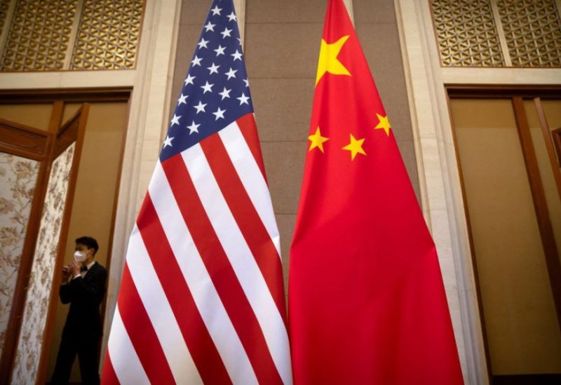 A staff member wearing a face mask walks past United States and Chinese flags set up before a meeting between Treasury Secretary Janet Yellen and Chinese Vice Premier He Lifeng at the Diaoyutai State Guesthouse in Beijing, China, Saturday, July 8, 2023. Mark Schiefelbein/Pool via REUTERS