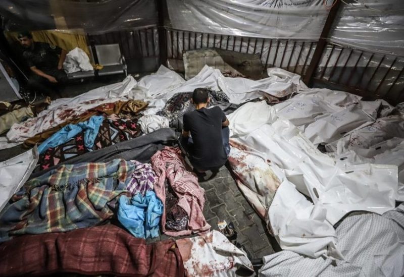 17 October 2023, Palestinian Territories, Gaza City: Bodies of Palestinians killed in an Israeli shelling on the Ahli Arab hospital, lie at al-Shifa hospital in Gaza City.