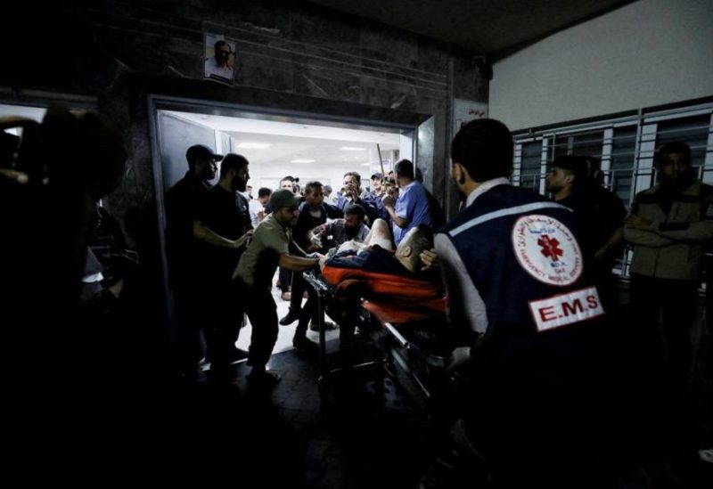 An injured person is assisted at Shifa Hospital after hundreds of Palestinians were killed in a blast at Al-Ahli hospital in Gaza that Israeli and Palestinian officials blamed on each other in Gaza City, Gaza Strip, October 17, 2023. (Reuters)