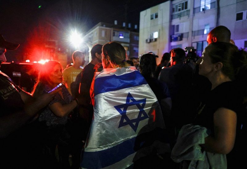 People gather after the news that Israeli soldier Ori Megidish, who was taken hostage by Hamas, was released following an Israeli ground operation inside Gaza according to the Israeli army, near her home in Kiryat Gat, Israel October 30, 2023. REUTERS/Evelyn Hockstein REFILE - QUALITY REPEAT