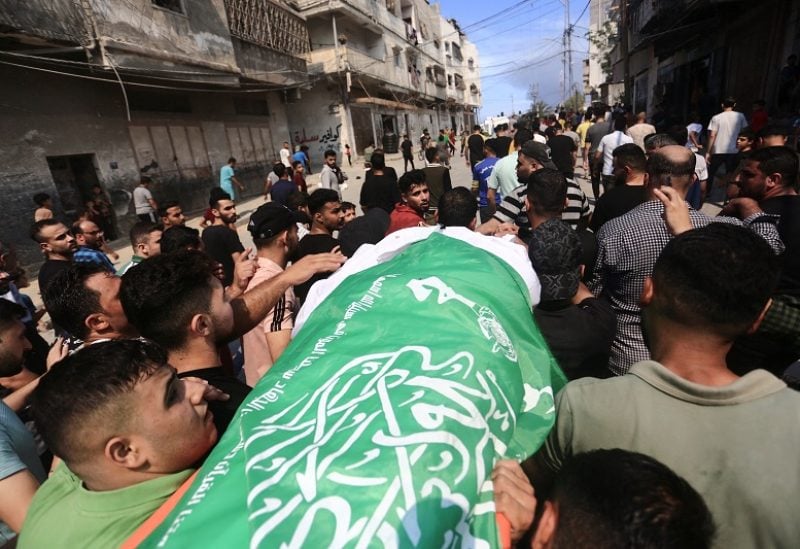 SENSITIVE MATERIAL. THIS IMAGE MAY OFFEND OR DISTURB Mourners attend the funeral of a Hamas militant, who was killed by Israeli forces, on the day Hamas launched a surprise attack on Israel, in the northern Gaza Strip October 7, 2023. REUTERS/Mahmoud Issa NO RESALES. NO ARCHIVES.