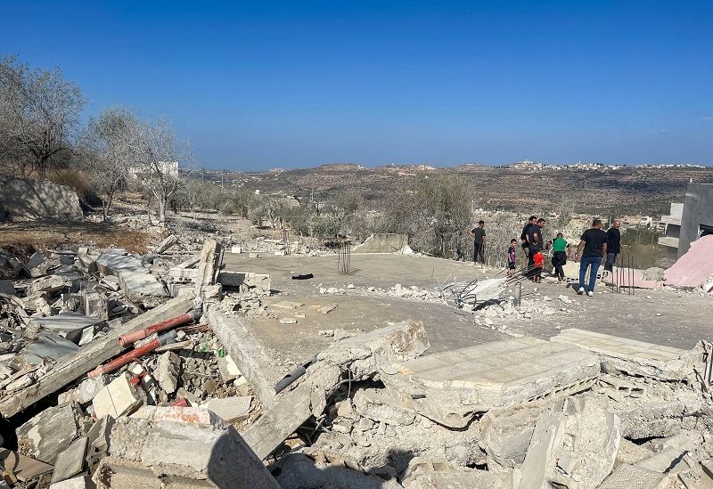 Palestinians stand on the rubble after Israeli forces demolished the house of Saleh al-Arouri, near Ramallah in the Israeli-Occupied West Bank October 31, 2023. REUTERS/Ismael Khader