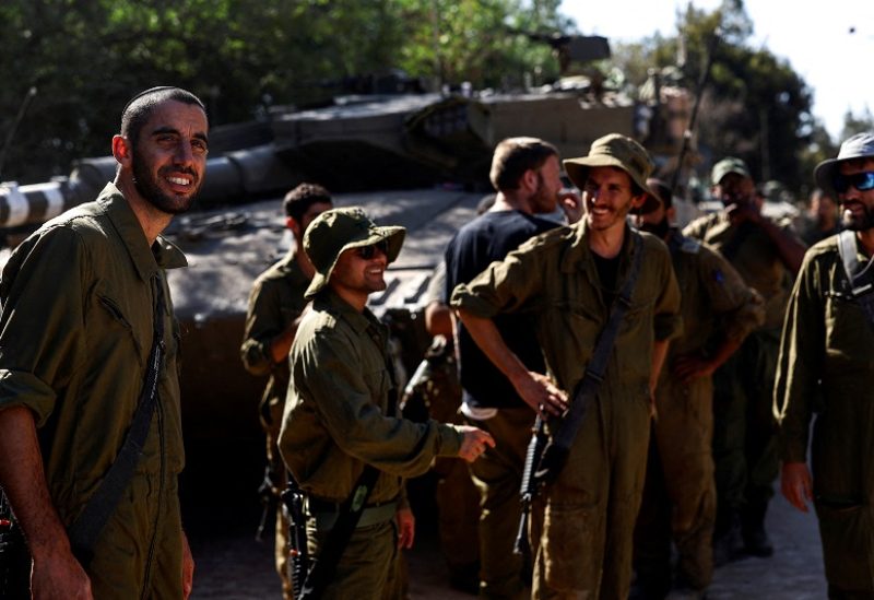 Israeli soldiers gather by military vehicles at Israel's border with Lebanon, in northern Israel, October 25, 2023. REUTERS/Lisi Niesner TPX IMAGES OF THE DA