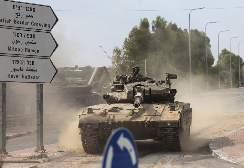 Israeli soldiers drive in a tank by Israel's border with Gaza in southern Israel, October 10, 2023. REUTERS/Ronen Zvulun