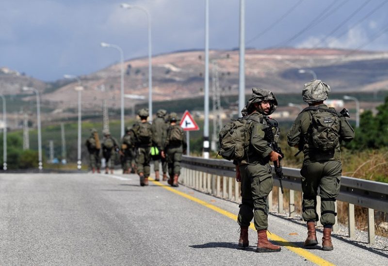 Israeli soldiers walk on a road near the Israel border with Lebanon amid heightened tensions between Israel and Lebanon, in northern Israel, October 19, 2023. REUTERS/Gil Eliyahu ISRAEL OUT. NO COMMERCIAL OR EDITORIAL SALES IN ISRAEL TPX IMAGES OF THE DAY